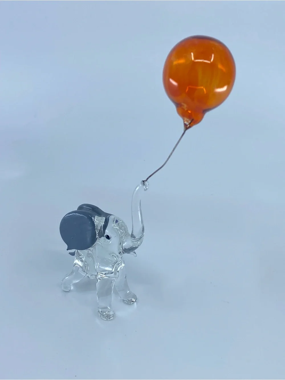 Hand-blown glass figurine resembles a circus elephant